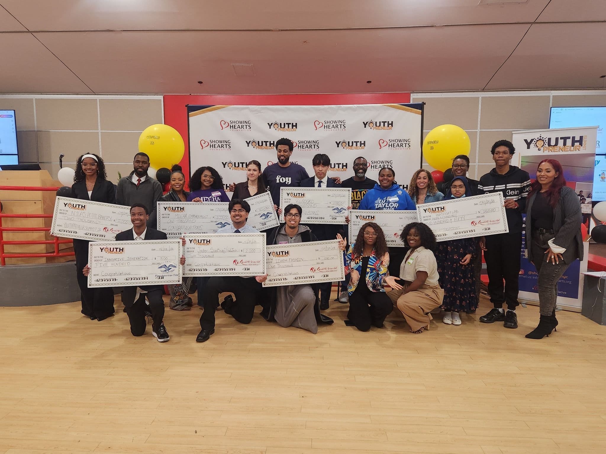 Pitch competition winners holding their checks at the Youthpreneur Summit