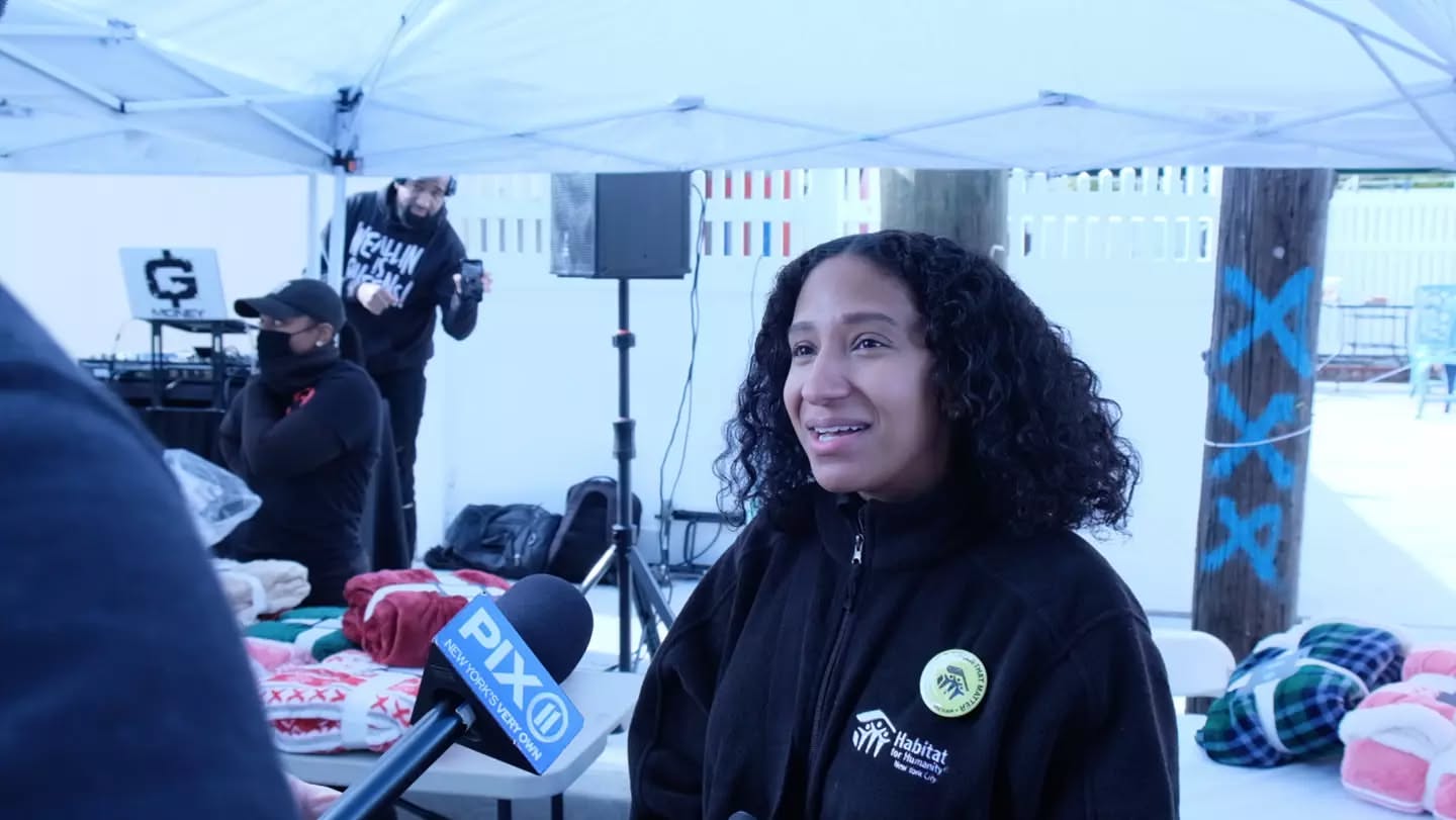 A partner from Habitat for Humanity NYC interviewed by PIX11 at a Showing Hearts blanket and coat giveaway